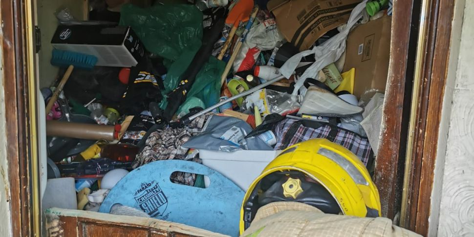Trapped hoarder rescued from c...