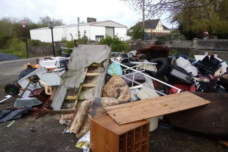 Council staff examining items illegally dumped in Castleisland to identify the culprits