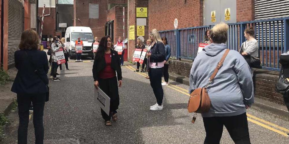 Debenhams workers in Cork hold...