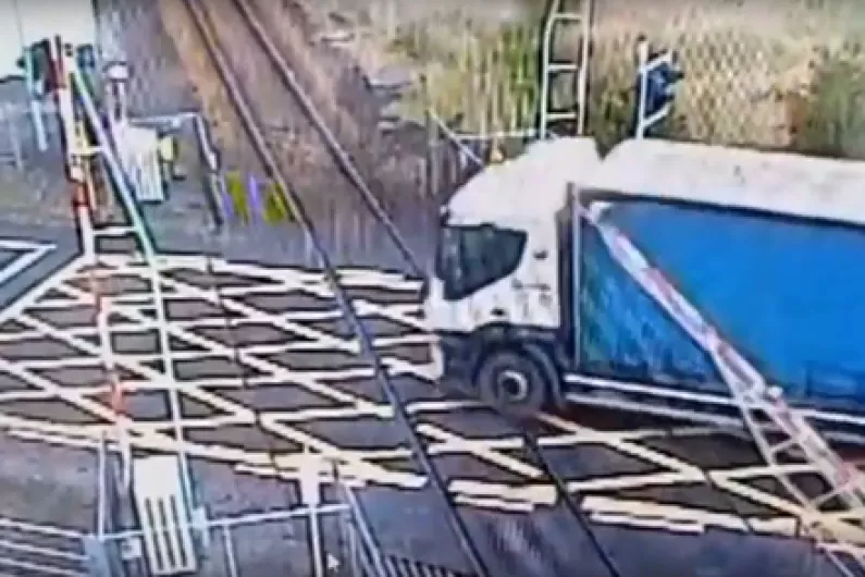 Major delays on local rail line after truck crashes through level crossing