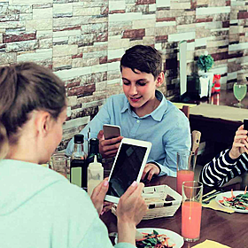 Three quarters of families admit to having their phones at the dinner table Image