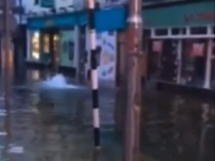 Man swims down flooded shopping street in Cork (video)