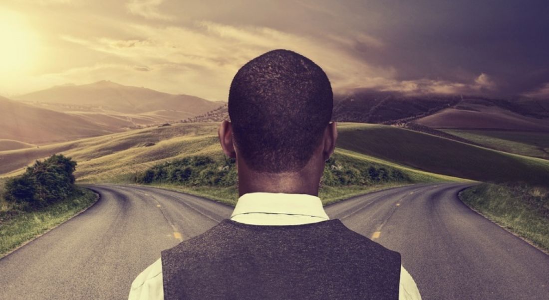 Man stands at a fork in the road