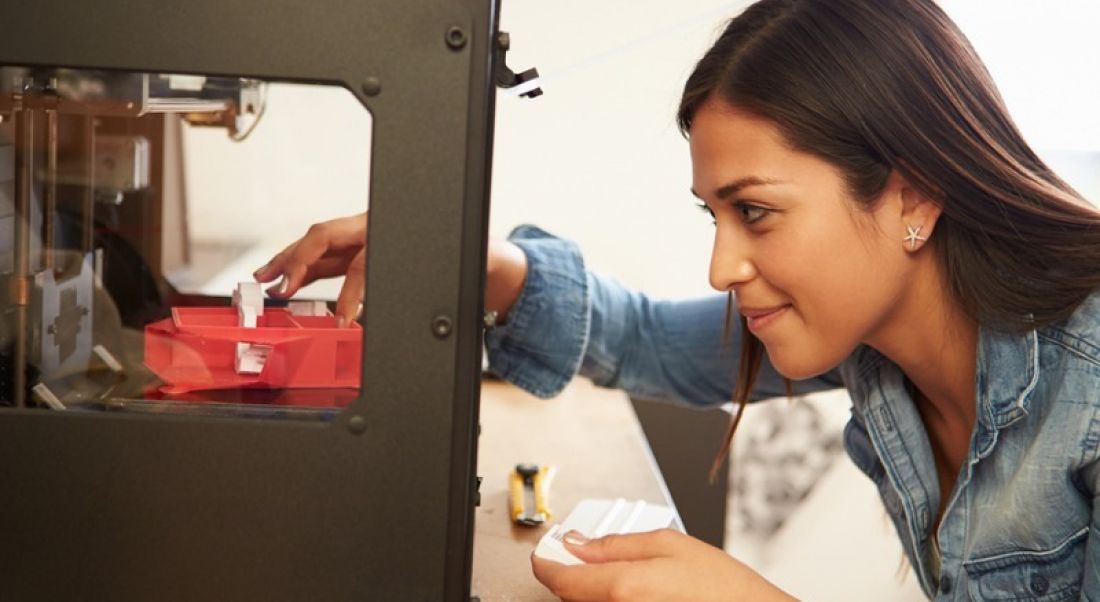 Woman using 3D printer