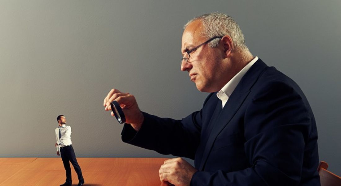 What do employers look for: Prospective employer examining candidate with magnifying glass