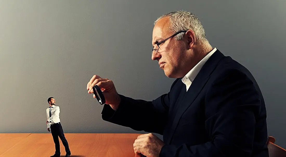 What do employers look for: Prospective employer examining candidate with magnifying glass