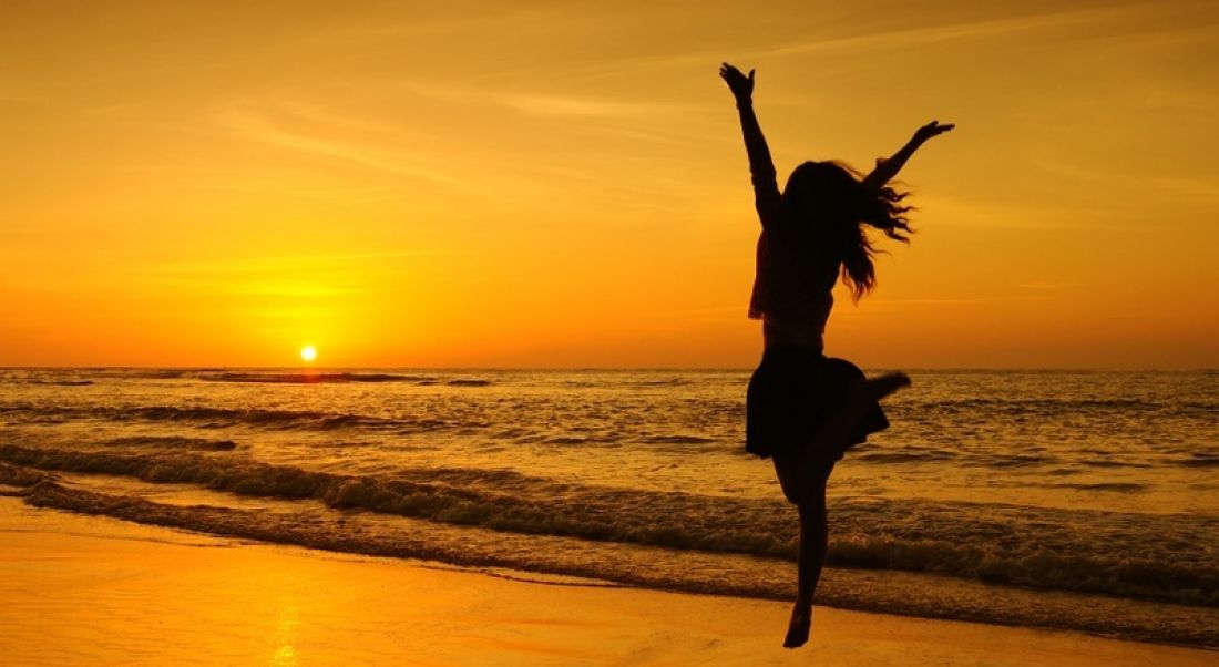 Jobs announcement: person jumping for joy, sunset, summer