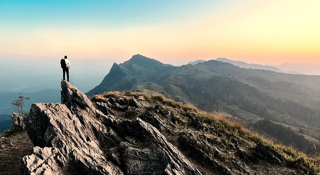 Bucket list: business person on top of mountain