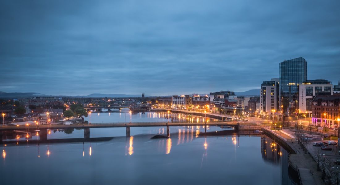 View over river Shannon of hotels and buildings in Limerick
