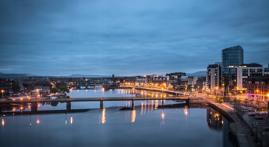 View over river Shannon of hotels and buildings in Limerick