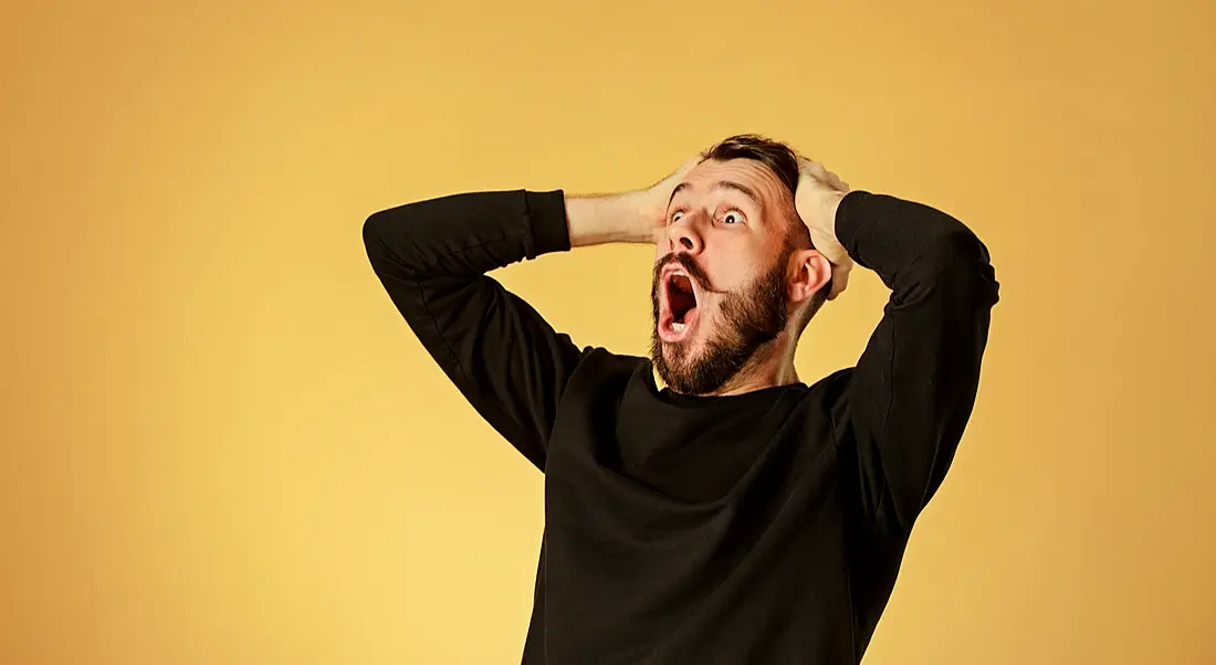 Man shocked and happy because of all the jobs announced against a yellow background