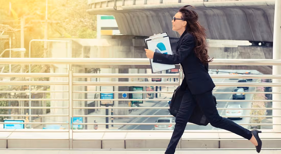 Young woman running with a folder, representing graduates rushing into their first job offer