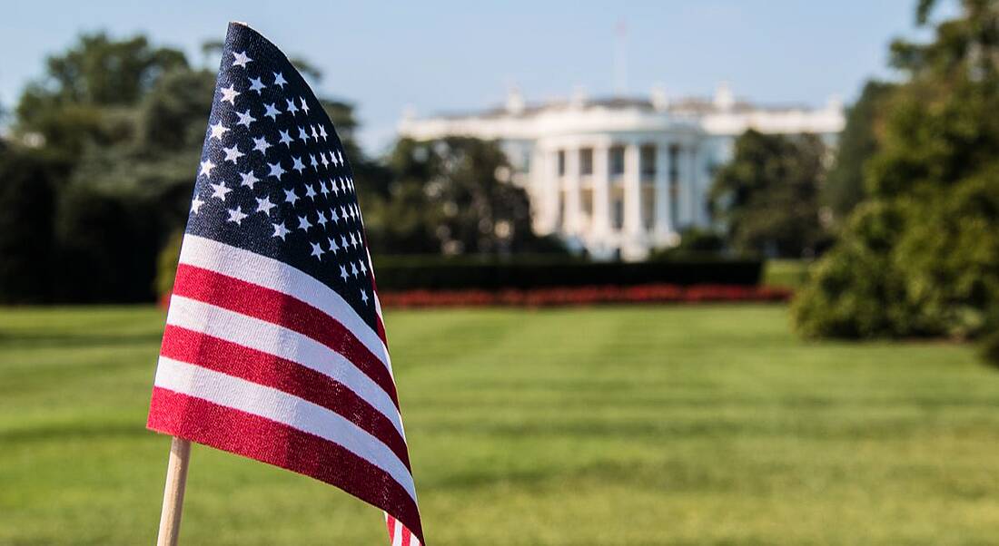 American flag waving in front of White House