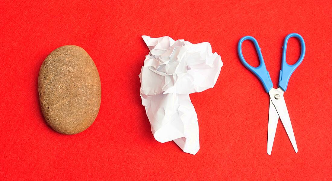 the elements used for rock paper scissors on a red background. decision making concept.