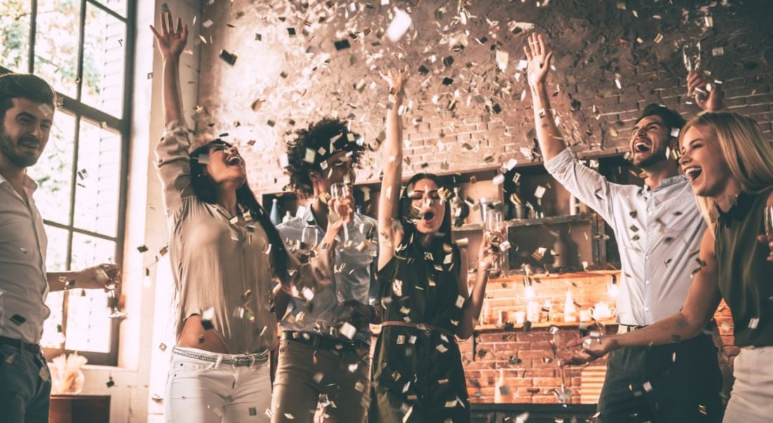 A group of happy people throwing confetti and celebrating all of the jobs in Ireland in July