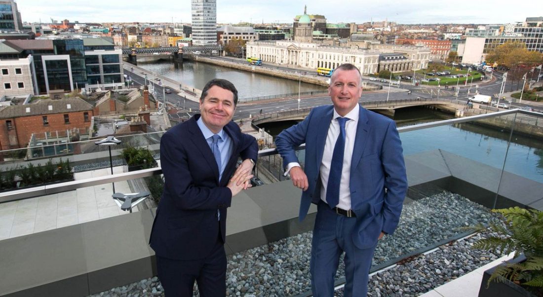 Two men leaning against the railing of a rooftop terrace overlooking Dublin at Grant Thornton offices.