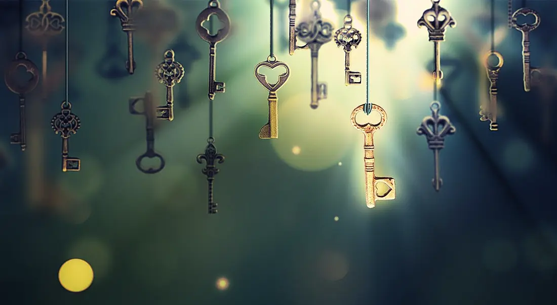 A conceptual image with hanging keys and one shining key.