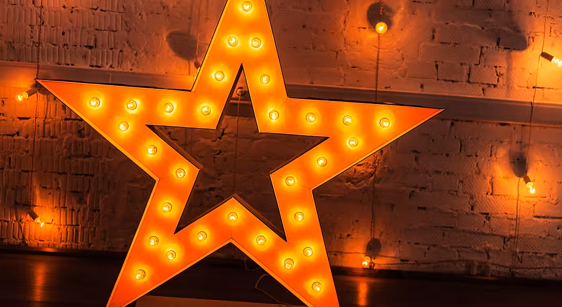 A glowing star against a background with a number of yellow lights symbolising making your CV shine.