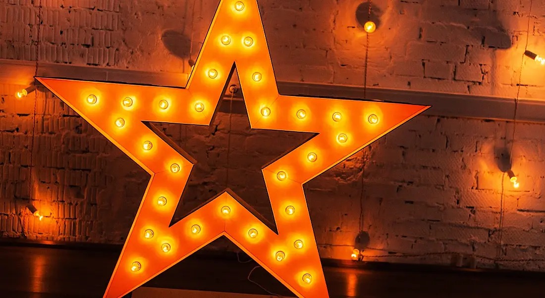 A glowing star against a background with a number of yellow lights symbolising making your CV shine.