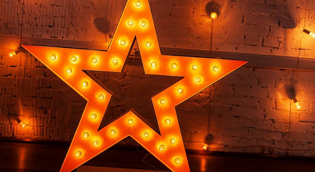 A glowing star against a background with a number of yellow lights symbolising making your CV shine.