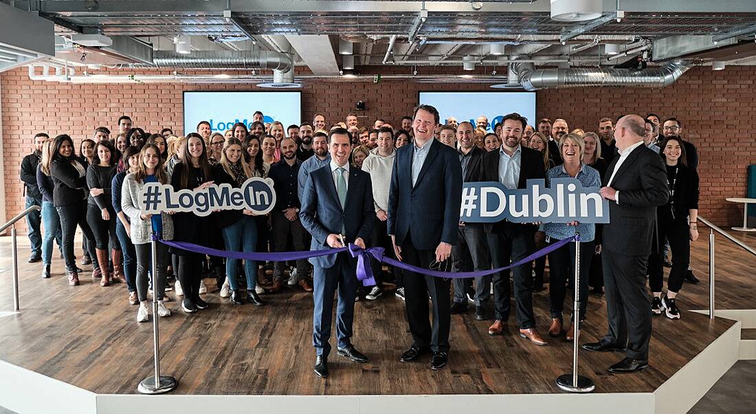 Large group of people at a ribbon-cutting ceremony at a tech company in Dublin.