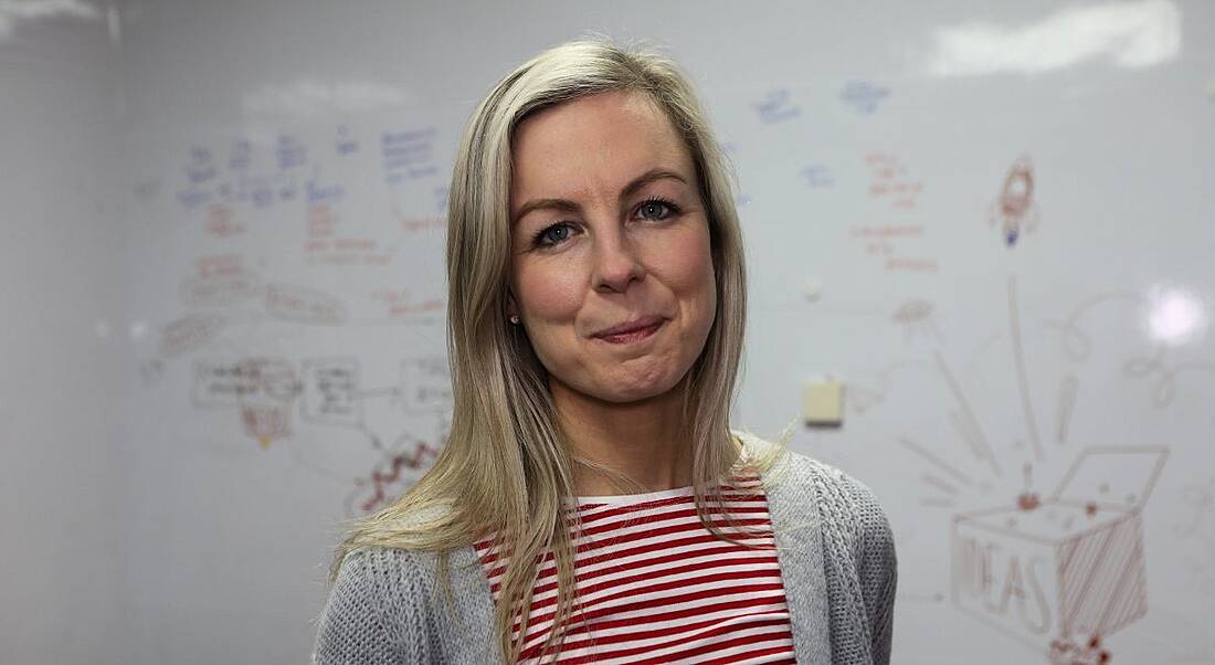 A headshot of a blonde woman smiling at the camera. She works for Johnson & Johnson.