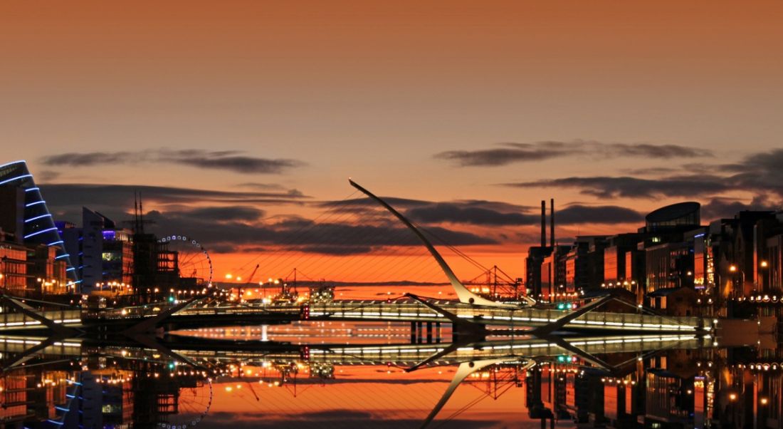 View of Dublin docklands and the Samuel Beckett bridge at sunrise.