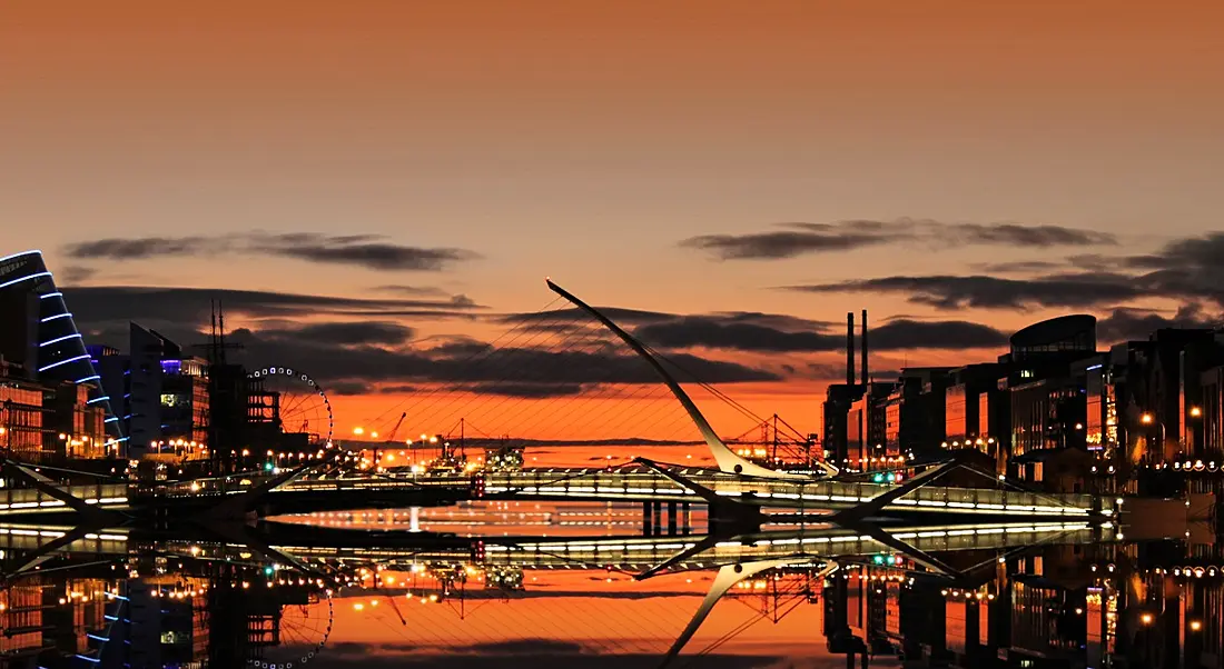 View of Dublin docklands and the Samuel Beckett bridge at sunrise.