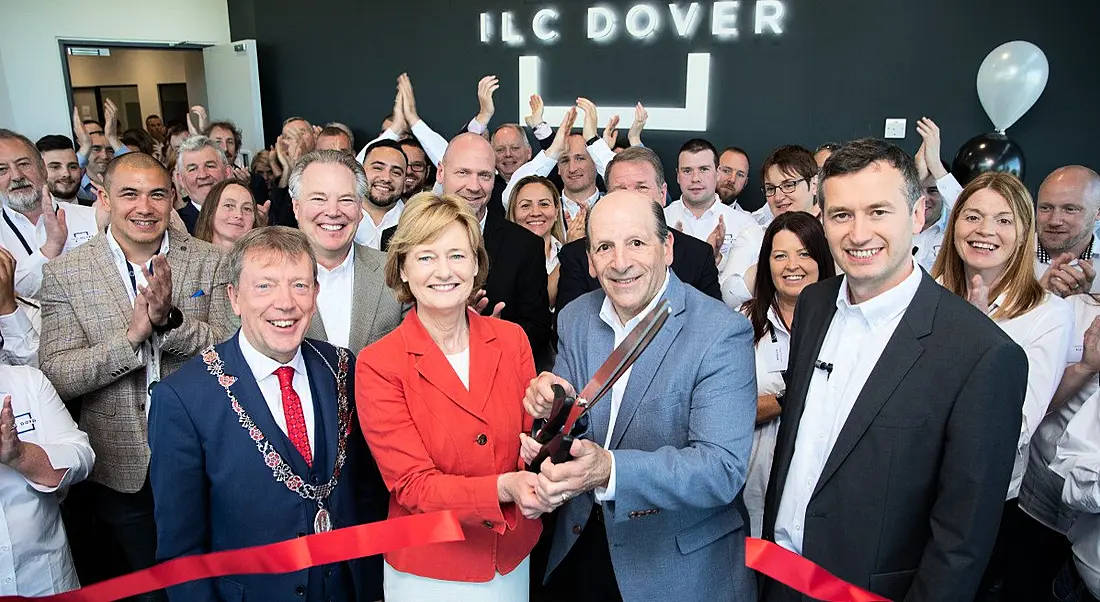 Dignitaries and staff at the opening of a new plant in Cork cutting a ribbon.