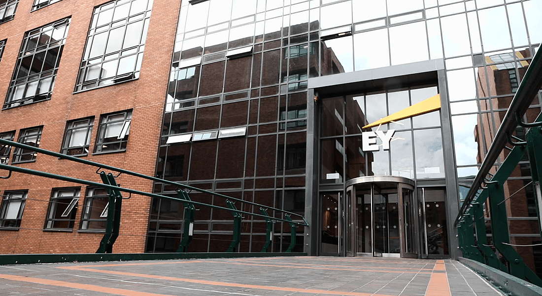 A view of the tall glass doors and palatial entry to EY offices in Dublin.