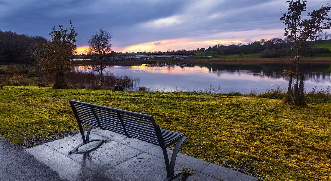 Photo of a bench facing a sunrise at Lough Lannagh, Castlebar, Co Mayo.