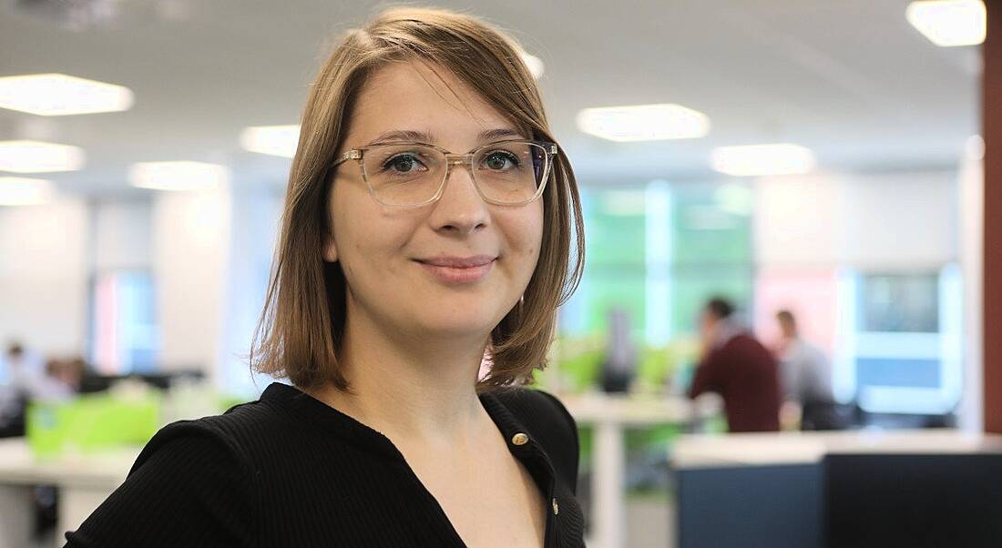 Headshot of a woman in casual clothes working in a corporate setting.