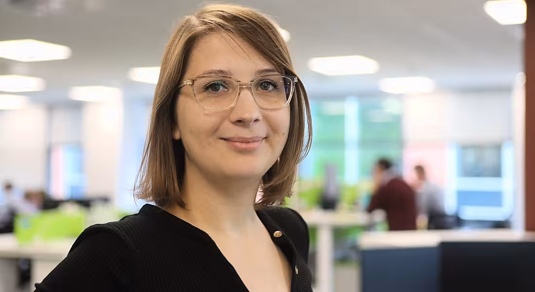 Headshot of a woman in casual clothes working in a corporate setting.