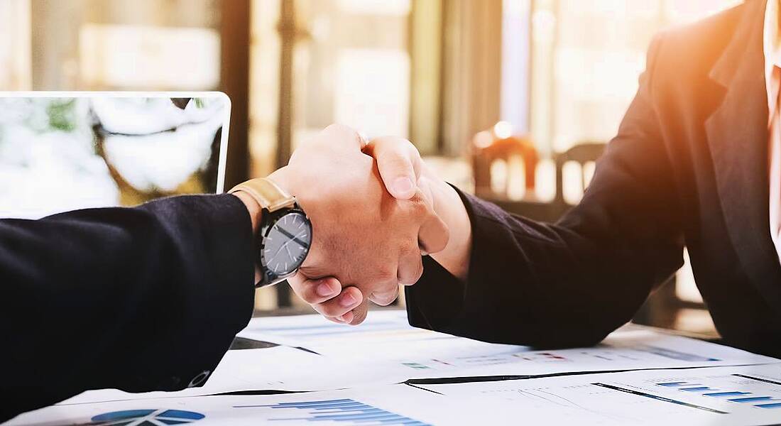 Business man and woman handshake, symbolising respect when letting staff go.