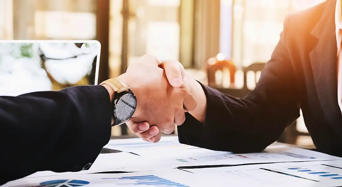 Business man and woman handshake, symbolising respect when letting staff go.