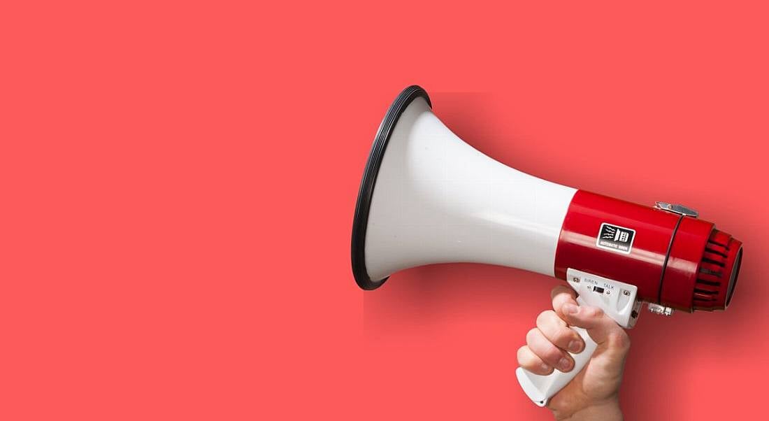 Image of a megaphone against a pink background.