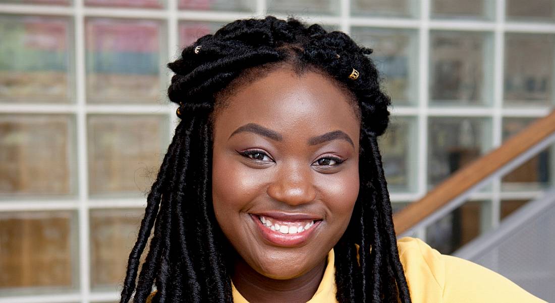 A close-up head shot of a smiling young woman. She is Zainab Boladale, News2day presenter on RTÉ.