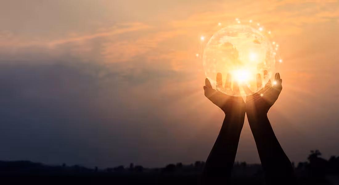 Hands holding global network and data exchanges on sunset background.