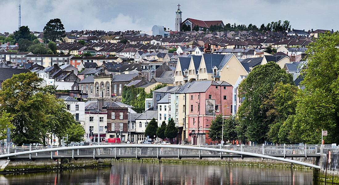 Cork cityscape with colourful buildings and a bridge across the river.