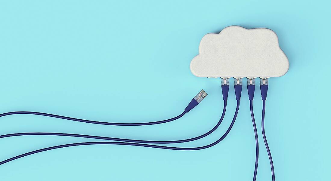 A white cloud has ethernet cables plugged into it on a blue background, symbolising cloud computing.