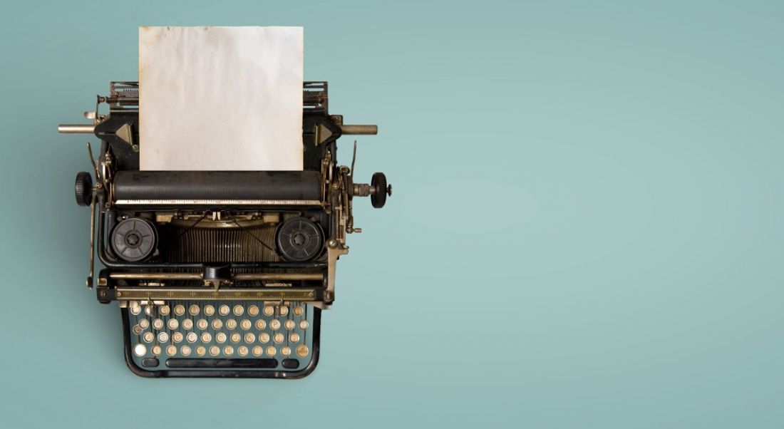 Vintage typewriter header with old paper on a teal background.