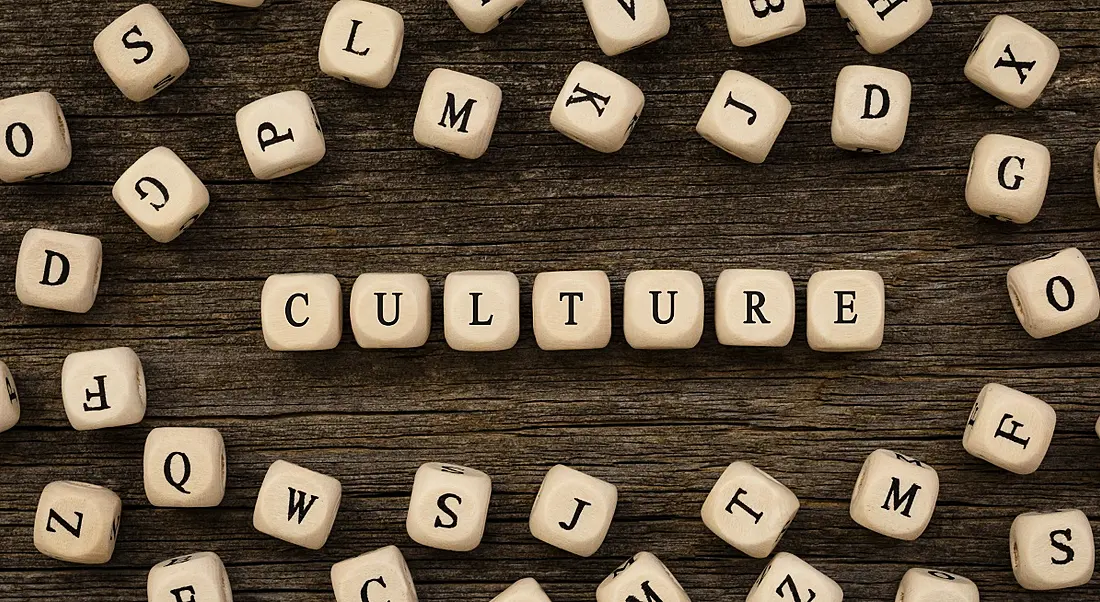 Wooden blocks with painted letters spelling out the word culture among other loosely organised blocks.