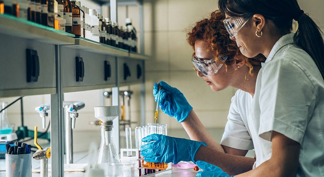 Two biopharma scientists working in a lab.