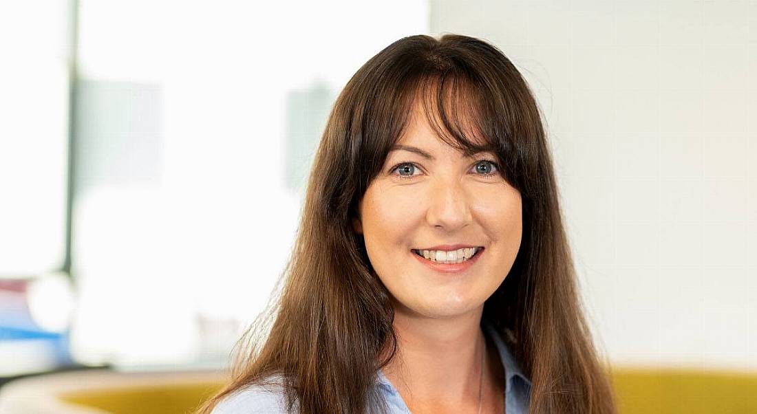 A headshot of a woman with brown hair smiles at the camera. She is Rachel Abernethy of Esri Ireland.