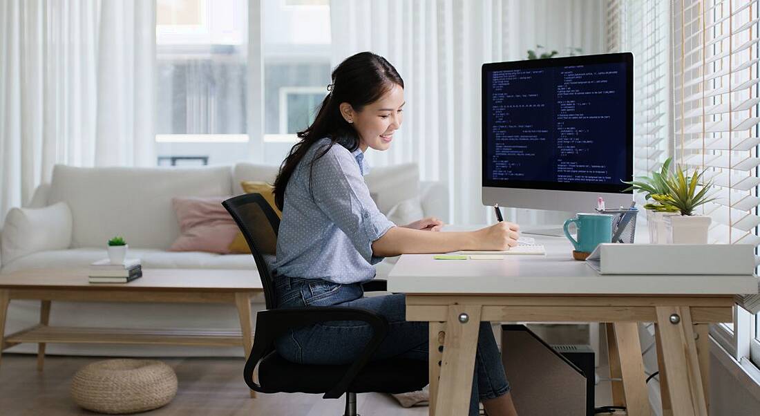 A young professional brushes up on the skills she needs, representing upskilling for roles such as cybersecurity analyst.