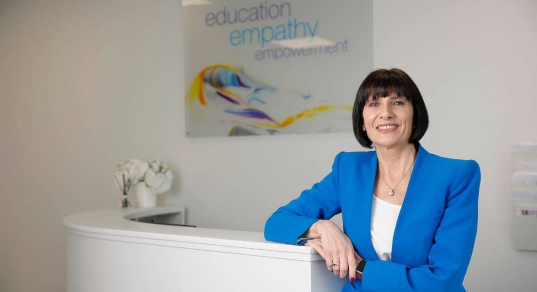 Loretta Dignam, CEO and founder of the Menopause Hub and Menopause Hub Academy, poses for the camera in a blue blazer.