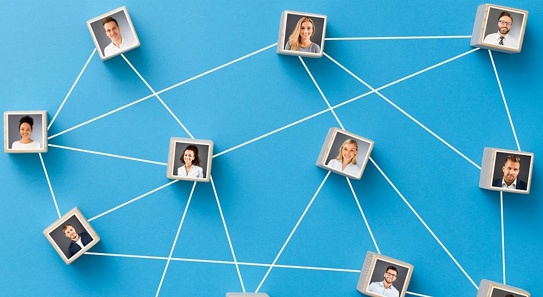 A chain of co-workers on a blue map represent the connected nature of networking.