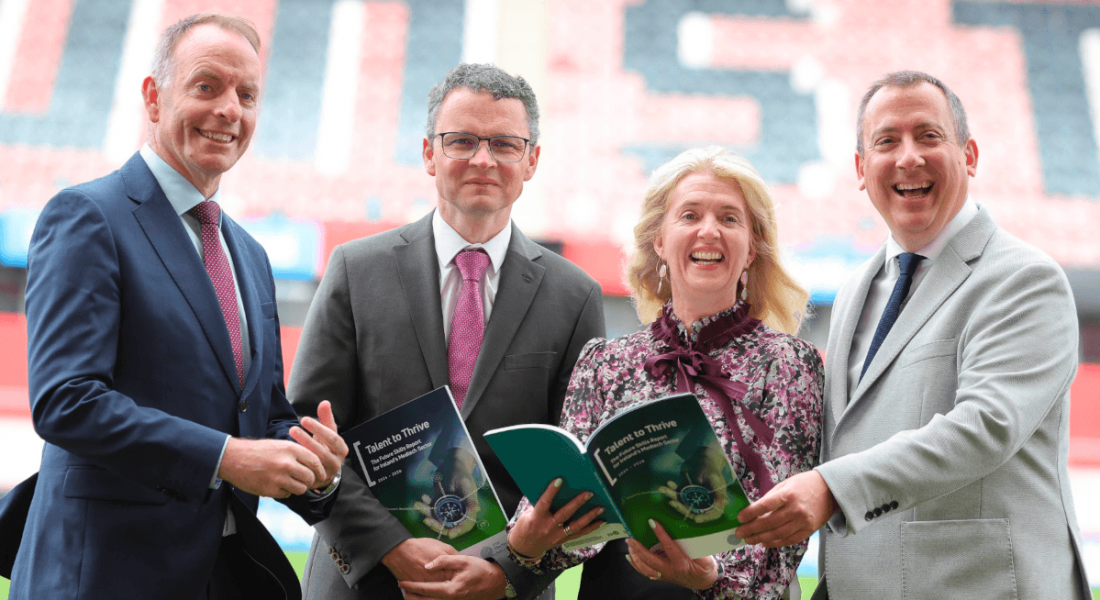 A woman and three men stand together in Thomond stadium at the Talent to Thrive: Future Skills for Ireland’s Medtech Sector launch.