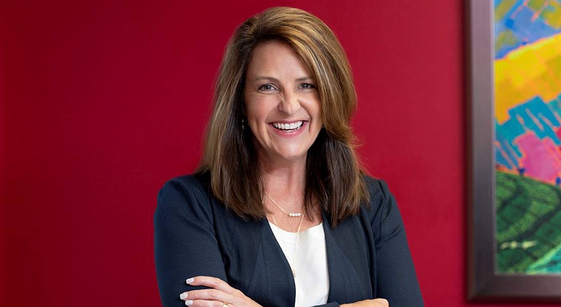 CEO of Emergenetics International Marie Unger, against a red background.