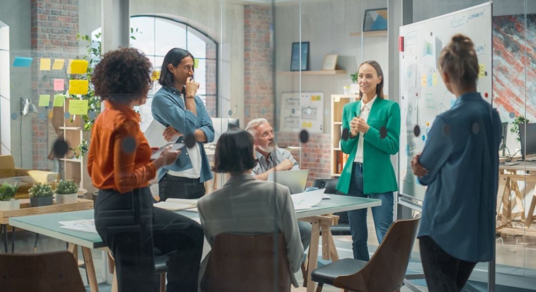 A female manager speaks with her team.